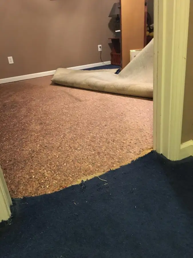 Carpet pad removal revealing water damage during Drying & Dehumidification in Holdenville